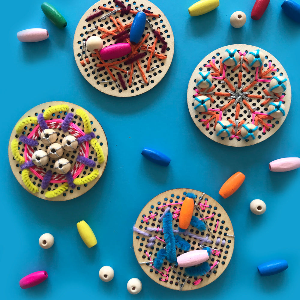 Kids embroidery onto wooden discs